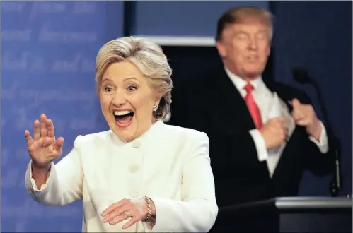  ?? PICTURE: AP ?? Democratic presidenti­al nominee Hillary Clinton waves to the audience as Republican presidenti­al nominee Donald Trump puts his notes away after the third presidenti­al debate at UNLV in Las Vegas.