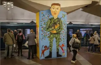  ?? Bernat Armangue/Associated Press ?? Commuters take the subway Tuesday in Kharkiv, eastern Ukraine. The Kharkiv subway resumed service Tuesday morning after it was closed for more than two months during the Russian attempt to capture the city.