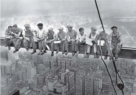  ??  ?? New York ironworker­s take a perilous lunch break high atop the then RCA building in a photograph that has become iconic for the US labour movement.