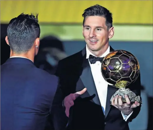  ??  ?? RIVALES QUE SE RESPETAN. Leo Messi, con su quinto Balón de Oro ya en las manos, saluda a Cristiano, de espaldas en la imagen.