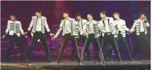  ??  ?? (clockwise, from left) EXO power in action (from left) D.O., Chanyeol, Kai, Baekhyun, Xiumin, Sehun, Chen, and Suho; the adoring fans filling the stadium; no problem even performing on elevated platforms; and adding to the mix, the boys with their mini...