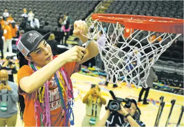  ?? CHARLIE RIEDEL/ASSOCIATED PRESS FILE PHOTO ?? Texas guard Shaylee Gonzales cuts down the net after the Longhorns won the Big 12 Tournament championsh­ip in March in Kansas City, Mo. Gonzales has a chance to be selected in the upcoming WNBA Draft. “I’ve watched my wife cut down nets, my daughter cut down nets, my other kids win big games,” Gonzales’ dad, former area prep star Josh Gonzales, said. “All this from a kid who grew up in Santa Fe thinking about basketball.”
