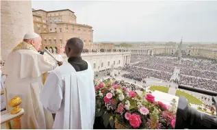  ?? AFP-Yonhap ?? This photo taken and handout, Sunday, by the Vatican media shows Pope Francis during the Easter “Urbi et Orbi” message and blessing to the city and the World from the central loggia of St Peter’s basilica in the Vatican.