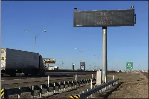  ?? (AP/Ty O’Neil) ?? A truck passes a warning sign about the Smokehouse Creek Fire on a highway in Amarillo, Texas, on Saturday.