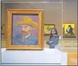  ??  ?? A visitor to the Metropolit­an Museum of Art looks at Van Gogh paintings.