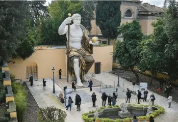  ?? TIZIANA FABI/GETTY-AFP ?? Monumental feat: Visitors on Tuesday marvel at a replica of a statue that 4th-century Emperor Constantin­e commission­ed for himself after AD 312. It was imagined using 3D modeling technology from scans of nine original marble parts. Constantin­e helped spread Christiani­ty in the Roman Empire. The statue is located at the Capitoline Museums in Rome.