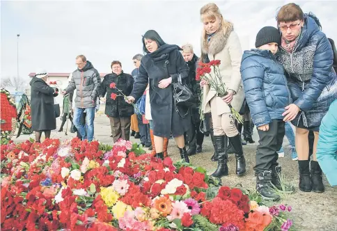  ??  ?? People lay flowers at the Sochi embankment the day after a Russian military plane crashed, the Russian military plane crashed on its way to Syria on Dec 25, with no sign of survivors among the 92 onboard, who included dozens of Red Army Choir members...