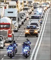  ?? JOHN SPINK / JSPINK@AJC.COM ?? A hearse with DeKalb Officer Edgar Isidro Flores is escorted from Whitfield Funeral Homes &amp; Crematory in Demorest on I-85 to Tuesday’s service.