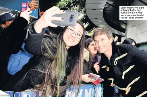  ??  ?? Eddie Redmayne signs autographs for fans during the Early Man world premiere held at the BFI Imax, London