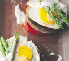  ??  ?? Mornay sauce is served Benedict-style over sunny-side up eggs, asparagus, whole portobello mushrooms and sliced tomato.