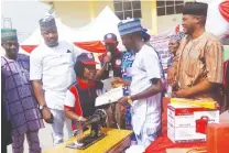  ?? Photo: Itodo Daniel Sule ?? Kogi State Commission­er for Youths and Sports, Prince Sani Salisu Ogu presenting a certificat­e and start up pack to one of the 300 beneficiar­ies of the National Industrial Skills Developmen­t Programme (NISDP) of the Industrial Training Fund (ITF) held...