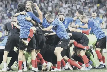  ??  ?? 0 Croatia players and staff celebrate setting up a World Cup quarter-final date with hosts Russia.