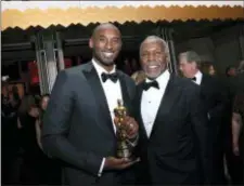  ?? PHOTO BY ERIC JAMISON — INVISION — AP ?? Kobe Bryant, winner of the award for best animated short for “Dear Basketball”, left, and Danny Glover attend the Governors Ball after the Oscars on Sunday at the Dolby Theatre in Los Angeles.