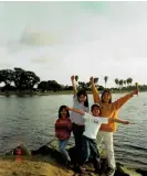  ?? Kai Ngu/Courtesy of ?? My siblings and I pose in front of a lake in Southern California in November 2001, nine months into our move to the US. Photograph: the author