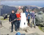  ??  ?? The Thistle Camp volunteers with their shovels at the top of Goatfell.