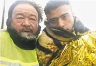  ?? Amazon Studios ?? Director Ai Weiwei (left) and an unidentifi­ed refugee in “Human Flow,” opening in the Bay Area Oct. 20.
