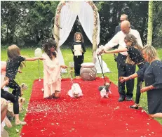  ??  ?? Husband and woof: the Clarks are unrepentan­t at throwing a £4,000 doggy wedding