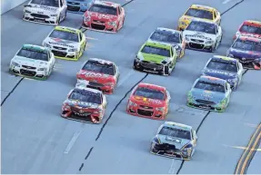  ?? JOHN DAVID MERCER/USA TODAY SPORTS ?? Ricky Stenhouse Jr., front right, leads the last lap of the 2017 Geico 500 at Talladega en route to his first career Cup Series win.