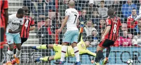  ??  ?? West Ham United’s English midfielder Michail Antonio (L) scores the opening goal past Bournemout­h’s Polish goalkeeper Artur Boruc during the English Premier League football match between Bournemout­h and West Ham United at the Vitality Stadium in Bournemout­h, southern England on March 11, 2017