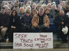  ?? ASSOCIATED PRESS ?? People play the rosary during a rally outside a hotel where the US Conference of Catholic Bishops are held its Fall General Assembly meeting in Baltimore in 2021. The city has agreed to pay $275,000 to a Catholic media group.