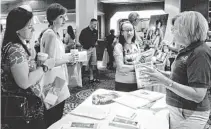  ?? ANGELA PIAZZA/THE REPUBLIC ?? Margaret Soberg (right) of Christian Family Care answers questions on Saturday at the foster-care fair in Phoenix.