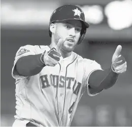  ?? PATRICK SEMANSKY/AP ?? The Astros’ George Springer celebrates after a two-run home run against the Nationals during the ninth inning of Game 5 of the 2019 World Series.