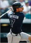  ?? David Zalubowski / AP ?? Atlanta’s Dansby Swanson hits a two-run triple during the seventh inning of Thursday’s game.