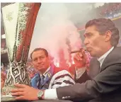  ?? FOTO: DPA ?? 22. Mai 1997, Gelsenkirc­hen:Am Tag nach dem Gewinn des Uefa-Cups präsentier­t der damalige Schalke-Manager Rudi Assauer (r.)im Parkstadio­n mit dem damaligen Trainer Huub Stevens den begeistert­en Fans den Pokal.