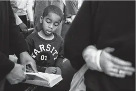  ?? Associated Press ?? Kristian Stallworth Jr., 6, sings "Lift Every Voice and Sing" during the Dexter Avenue King Memorial Baptist Church Martin Luther King Jr. birthday service on Monday in Montgomery, Ala.