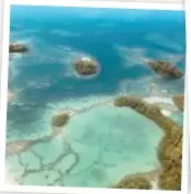  ??  ?? Specks in the ocean ... (from left) islands and reef in the turquoise Pacific; Papatura's owners Peter and Margie Blanche; a board ready to go.