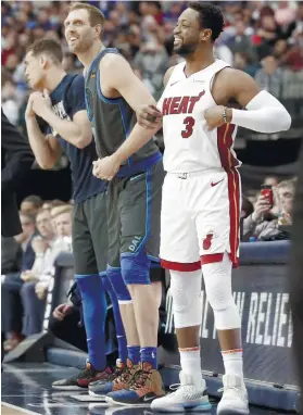  ?? AP FOTO ?? MEMORY LANE. Dallas Mavericks forward Dirk Nowitzki shares a laugh with Miami Heat guard Dwyane Wade as they enter the court together. Wade beat Nowitzki in the 2003 NBA finals.
