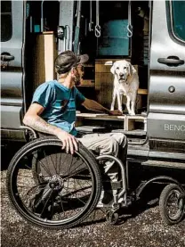  ?? CLAYTON WILLIAMS ?? Williams with his dog, Bella, and his specially outfitted van. His biggest hurdle, he said, was the cost of the modificati­ons to his Ford Transit van.