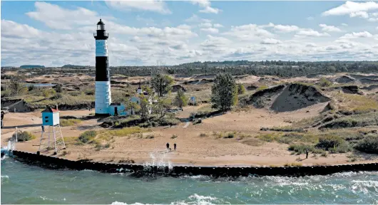  ?? ZBIGNIEW BZDAK/CHICAGO TRIBUNE ?? The Big Sable Point Lighthouse stands at Ludington State Park in Michigan. A seawall was built to protect the historic, active lighthouse.