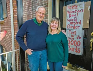  ?? JERRY JACKSON/STAFF ?? Peter and Kimberly Kaestner stand outside their Cockeysvil­le home, which Kimberly had decorated to celebrate Peter’s 10,000th recorded bird species this month in the Philippine­s. Kaestner turned an interest in birds at a young age into a lifelong goal to see as many different species as he could.