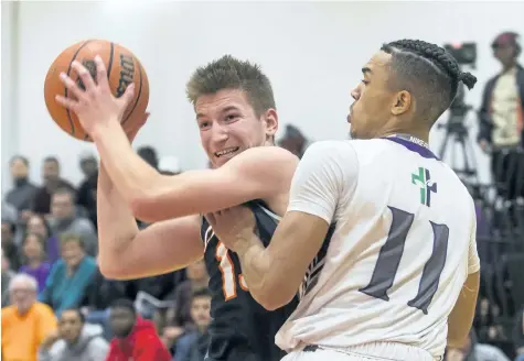  ?? JULIE JOCSAK/STANDARD STAFF ?? Reese Radabenko of the Centennial Cougars tries to keep the ball away from Tyrell MacLennan of the St. Francis Phoenix in the championsh­ip game of the St. Catharines Standard Boys High School Basketball Tournament at St. Catharines Collegiate Friday.