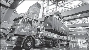  ?? AP ?? A worker waits to transport goods at the container port in Qingdao in eastern China’s Shandong province. China’s exports rose 0.5 percent in 2019 on stronger demand from other markets.