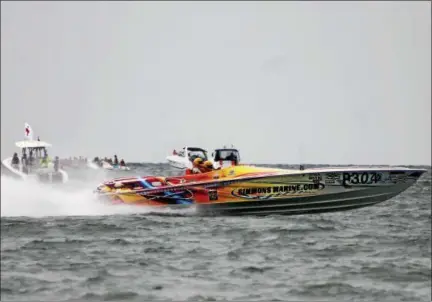  ?? KRISTI GARABRANDT — THE NEWS-HERALD ?? Super Boats race across Lake Erie during the second annual Mentor Super Boat Grand Prix that took place at Headlands Beach State Park July 23.