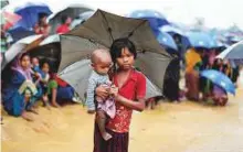  ?? Reuters ?? Rohingya refugees queue to receive food at a refugee camp near Cox’s Bazar, Bangladesh. One in five Rohingya children under age five is estimated to be malnourish­ed.