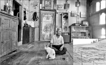  ??  ?? Zeko, 73, poses for a portrait at his home in Punakha. “I’m happy to have a mobile phone so I can talk to my relatives and children any time I want,” Zeko said.