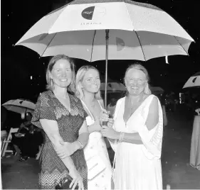  ??  ?? No amount of rain could stop members of the Steuart family from enjoying their hotel’s 65th anniversar­y party. From left are Katherine Steuart, Honor Upton, and Jennifer Steuart.