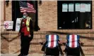  ?? Photograph: Matthew Hatcher/Getty Images ?? A poll worker sits outside and assists voters at a polling station in Columbus, Ohio, in November.