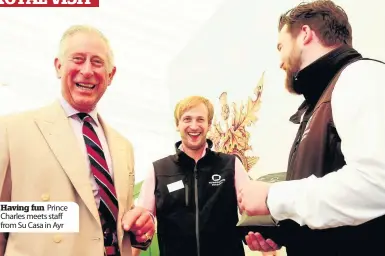  ??  ?? Having fun Prince Charles meets staff from Su Casa in Ayr