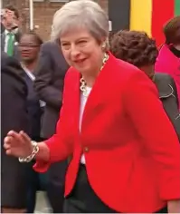  ??  ?? In out, in out: Mrs May shakes it all about at a school in Cape Town yesterday