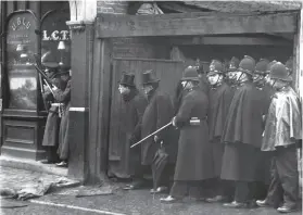  ??  ?? The Siege of Sidney Street in1910 with Winston Churchill observing at the front, and the stainless steel portraits in Angel Alley.