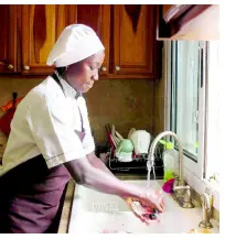  ??  ?? In this Nov. 24, 2018 photo, Chef Touty Sarr scrapes the scales off a red snapper to boil in the savory broth of thiebou dieune, a traditiona­l Senegalese dish of spiced rice, inside a kitchen in Ngaparou, Senegal.