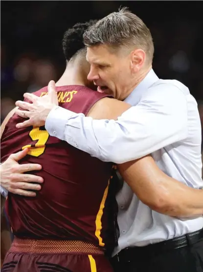  ?? DAVID J. PHILLIP/ AP ?? With the game out of reach, Loyola coach Porter Moser hugs junior Marques Townes during the second half Saturday.