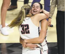  ??  ?? David Becker / Associated Press Gonzaga guard Jill Townsend (32) and forward Jenn Wirth embrace after Townsend’s jumper upended BYU.