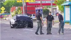  ?? ADOLPHE PIERRE-LOUIS/JOURNAL ?? Bernalillo County Sheriff’s Office deputies investigat­e a crash involving an Albuquerqu­e police officer. A 6-year-old boy died as a result of the wreck.