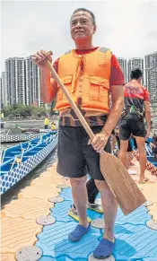  ??  ?? I DO MY BIT: Lau Fat, 65, a blind paddler on the team, before boarding his boat.