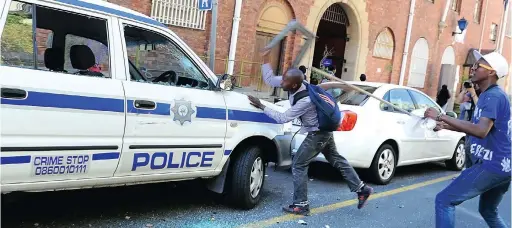  ?? PICTURE: Phando Jikelo ?? BREAK SOME MORE: Protesting students smashed police cars as they ran from Parliament where they delivered their memorandum.